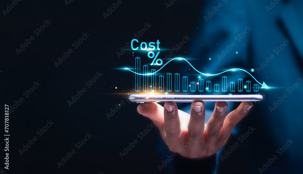 Cost reduction business finance concept. Businessman with virtual screen of Cost reduction graph with down arrow for budget management and cost management.