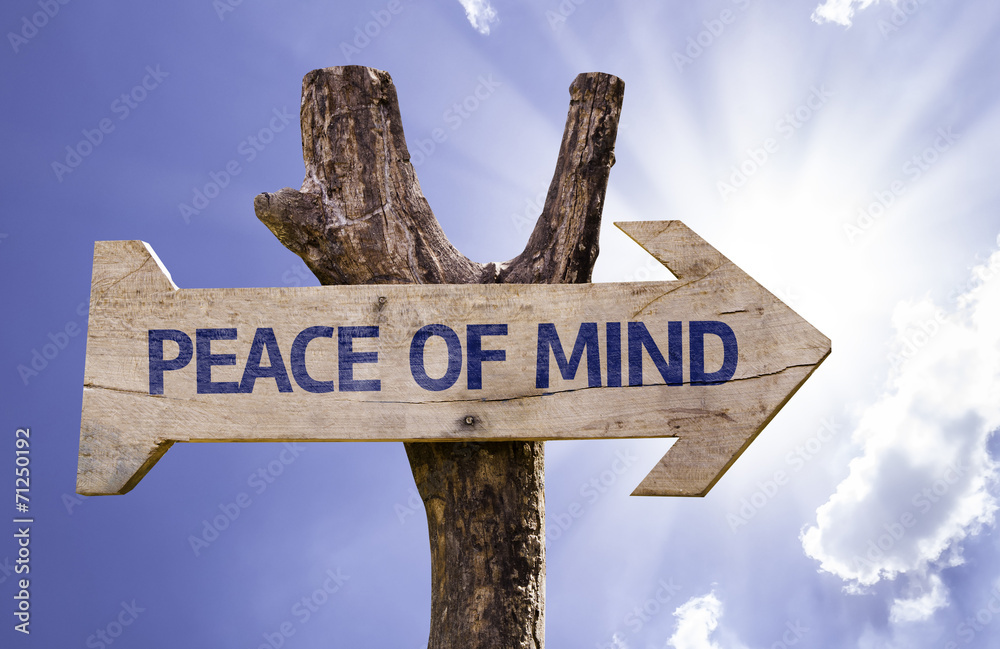 Peace of Mind wooden sign with a sky background