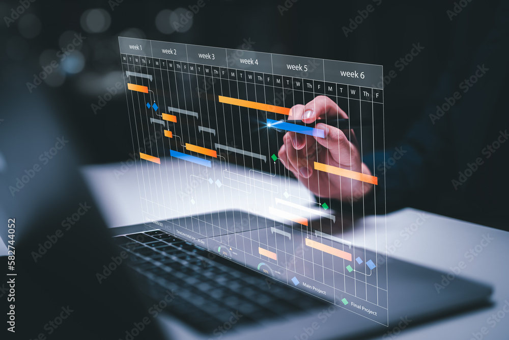 Planning and Implementation, Business people use laptop computers to manage work projects and update tasks. Work progress, efficient scheduling.Business Data Management scheduling interface